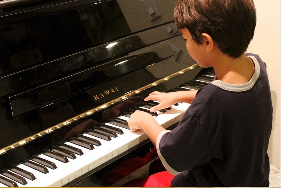 a boy practicing piano